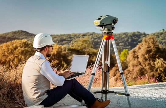 Surveyor working on his laptop next to LiDAR Scanner - Pointorama